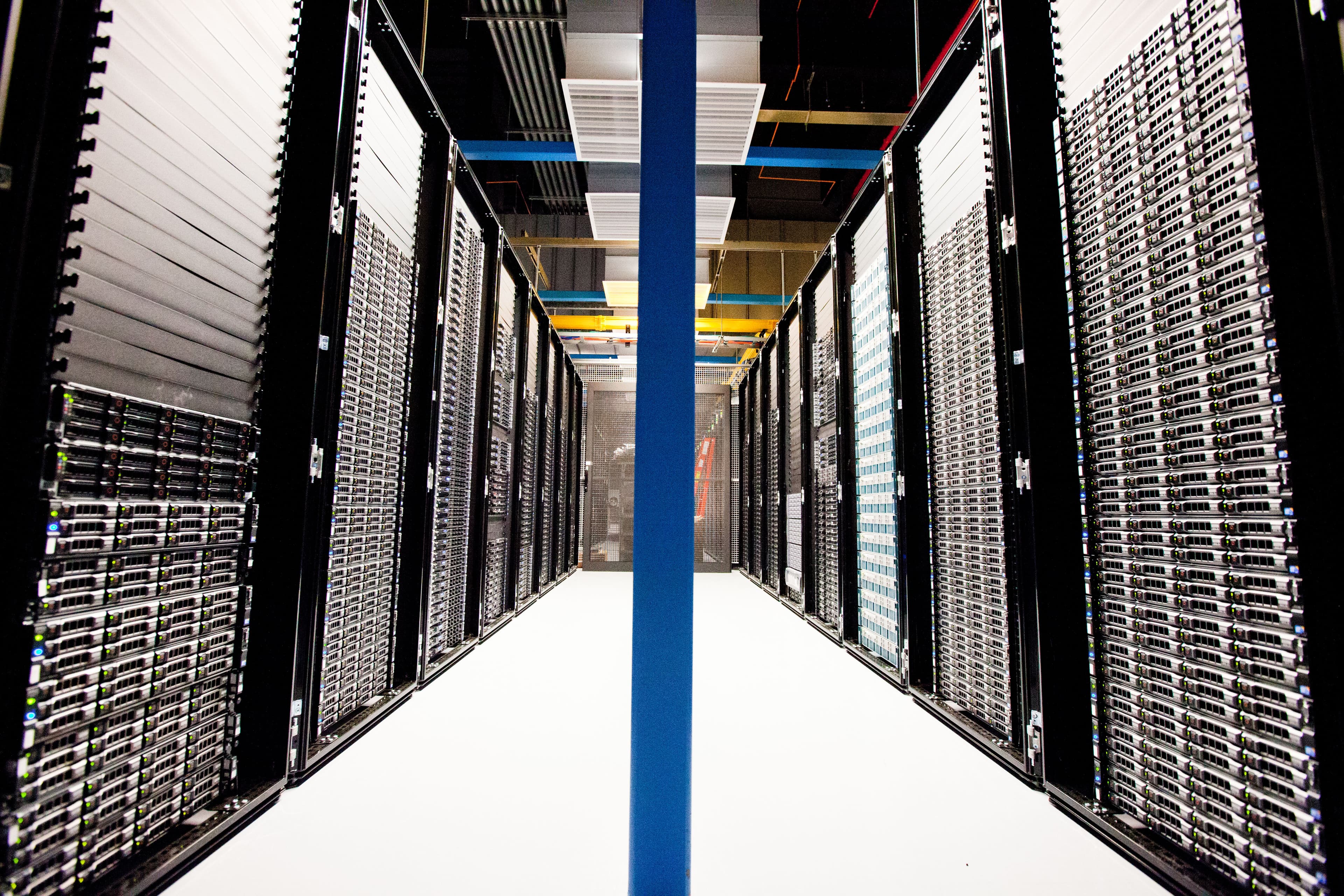 Rows of server racks in a data center, representing the AI infrastructure demand driving semiconductor and hyperscaler stocks